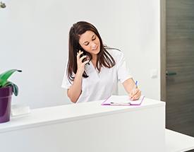 female student in business attire at computer